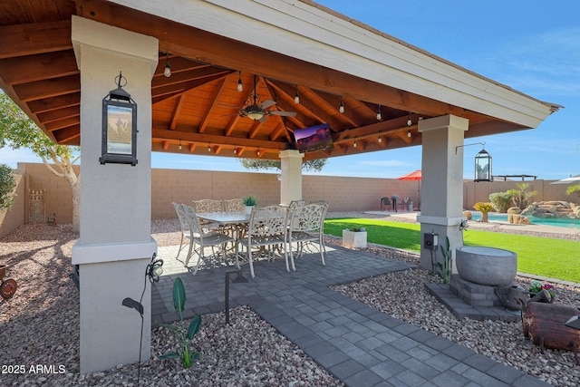 view of patio / terrace with a fenced backyard, outdoor dining area, and a gazebo