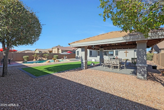 view of yard with a patio, outdoor dining area, a fenced backyard, and a fenced in pool