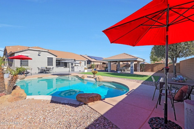 view of swimming pool with a patio area, a fenced backyard, a fenced in pool, and a gazebo