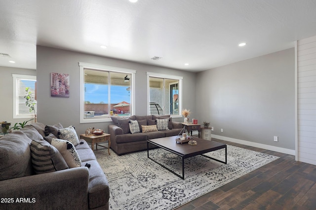 living room featuring baseboards, visible vents, wood finished floors, and recessed lighting