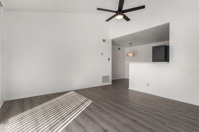 unfurnished living room featuring ceiling fan, vaulted ceiling, and dark hardwood / wood-style flooring