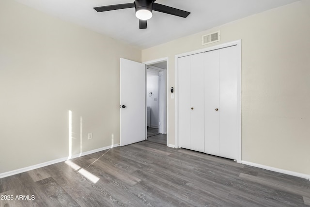 unfurnished bedroom with ceiling fan, a closet, and wood-type flooring