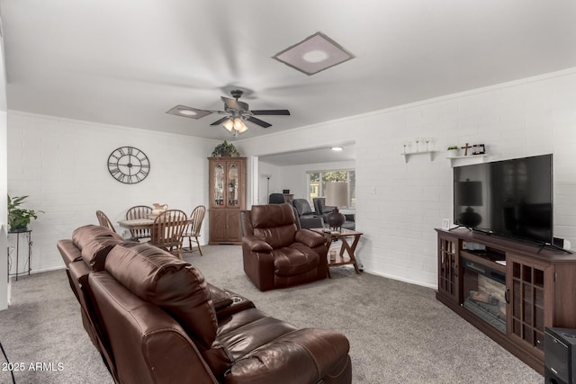 living room featuring ceiling fan, brick wall, and carpet flooring