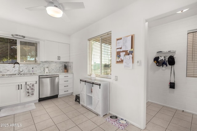 kitchen featuring ceiling fan, dishwasher, sink, white cabinetry, and light tile patterned floors