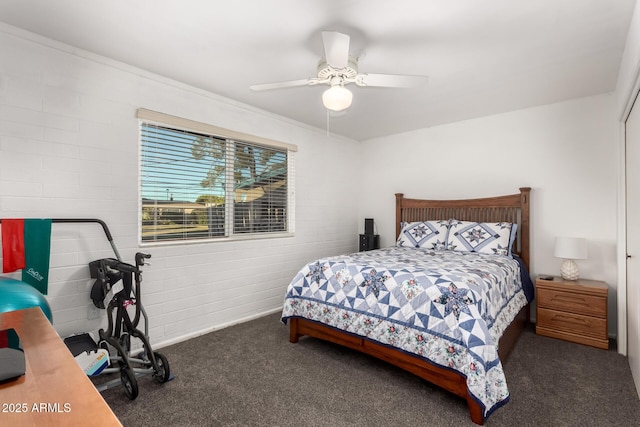 bedroom featuring ceiling fan, brick wall, and dark carpet