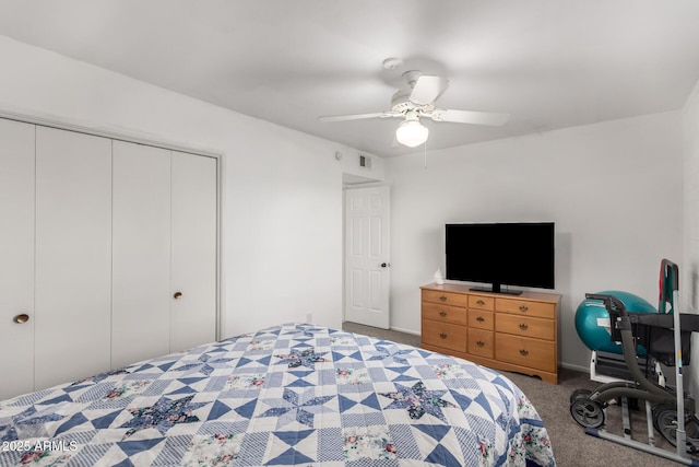 carpeted bedroom with ceiling fan and a closet