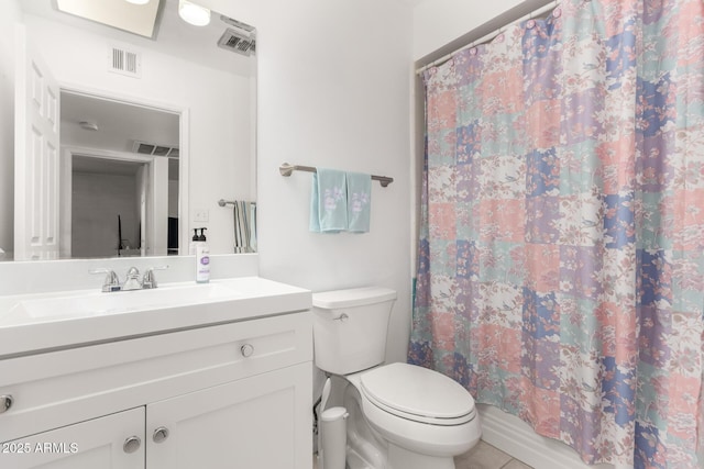 bathroom featuring toilet, vanity, and tile patterned flooring