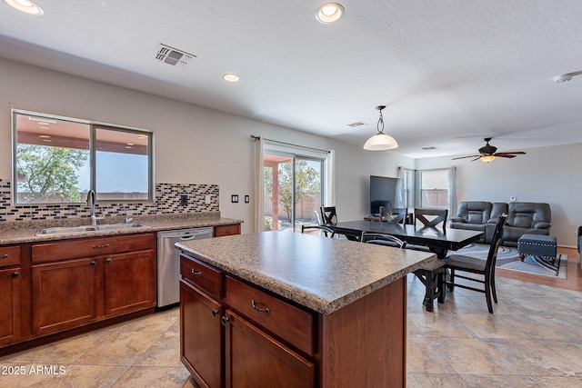 5305 E Silverbell Rd, San Tan Valley, AZ 85143 - kitchen featuring a sink, dishwasher, tasteful backsplash, a center island, and pendant lighting