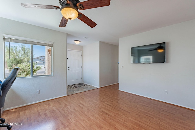 5305 E Silverbell Rd, San Tan Valley, AZ 85143 - unfurnished living room featuring wood finished floors, baseboards, and ceiling fan