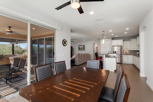 dining area featuring ceiling fan and sink