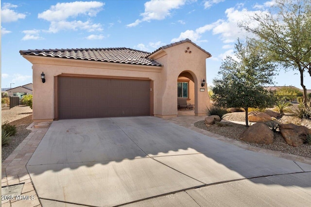 mediterranean / spanish-style home with a garage