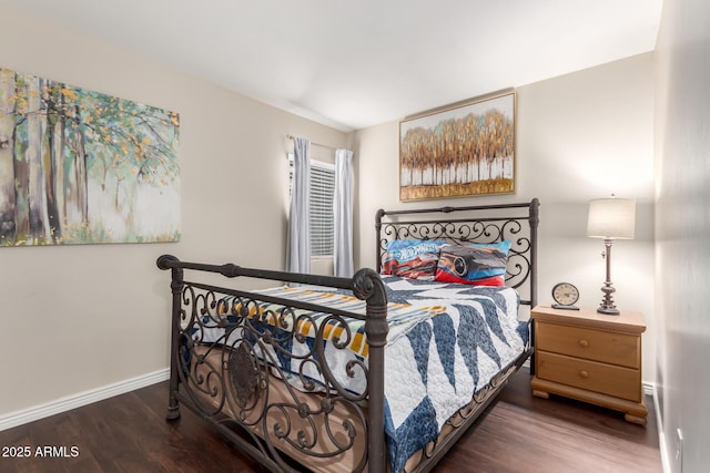 bedroom featuring baseboards and wood finished floors