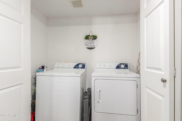 laundry area with laundry area, visible vents, and independent washer and dryer