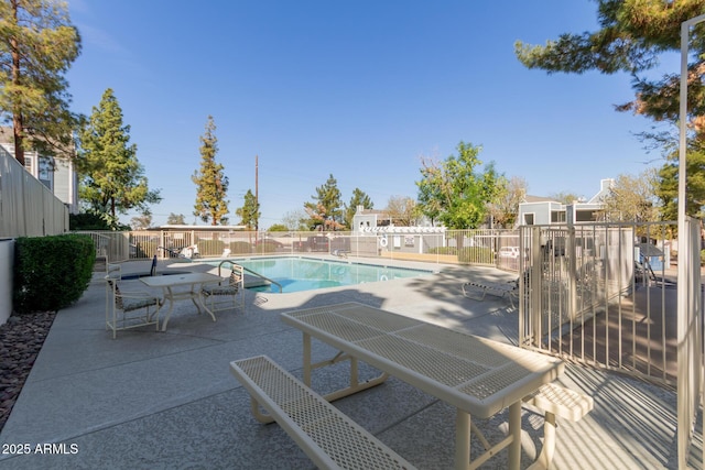 pool featuring a patio and fence