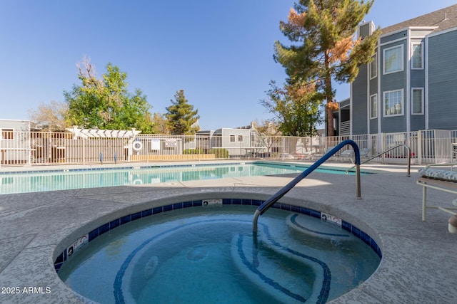 pool with fence and a community hot tub