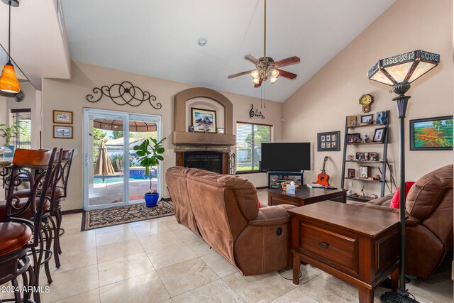 tiled living room with high vaulted ceiling and ceiling fan