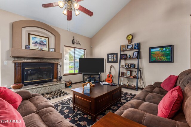 living room with ceiling fan, high vaulted ceiling, and a high end fireplace