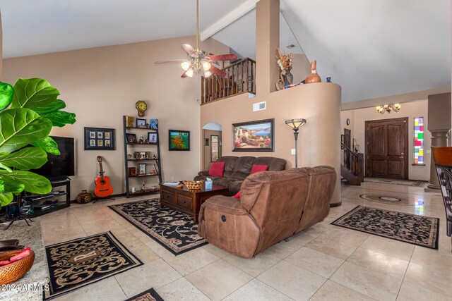 tiled living room with beam ceiling, high vaulted ceiling, and ceiling fan with notable chandelier