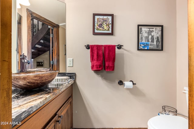 bathroom featuring vanity and toilet