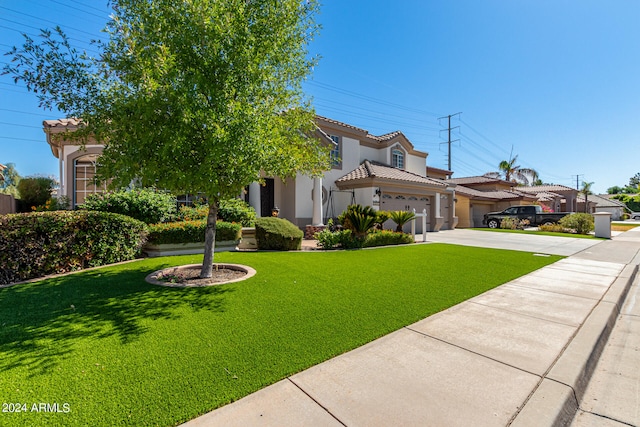 mediterranean / spanish house featuring a front lawn and a garage