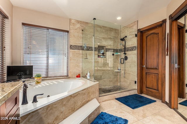 bathroom with shower with separate bathtub and tile patterned flooring