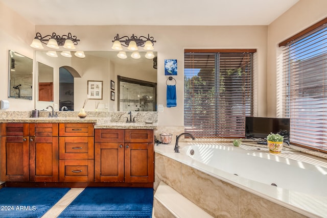 bathroom featuring vanity and shower with separate bathtub