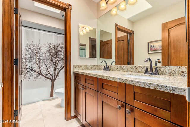 bathroom featuring vanity, toilet, and tile patterned floors