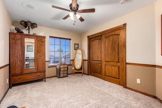 sitting room featuring light colored carpet and ceiling fan