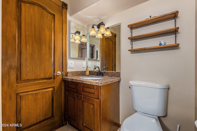 bathroom featuring toilet and vanity