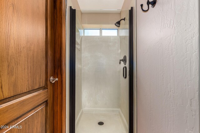 bathroom with a shower with shower door