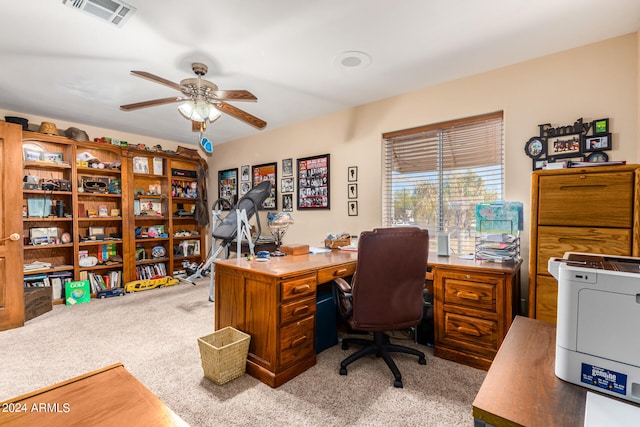 carpeted office space featuring ceiling fan