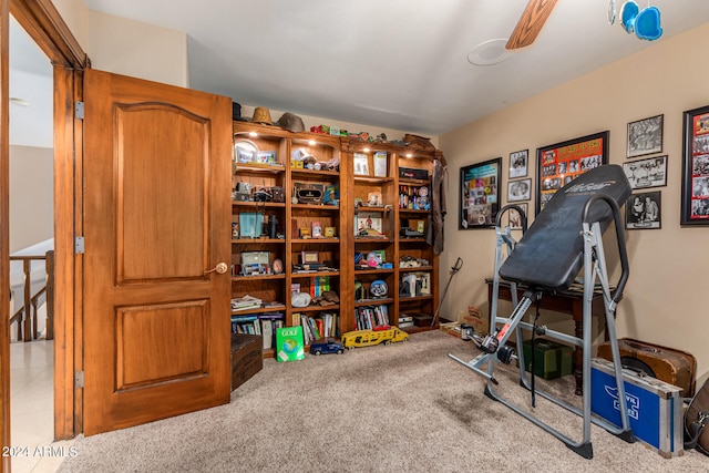 workout room with light carpet and ceiling fan