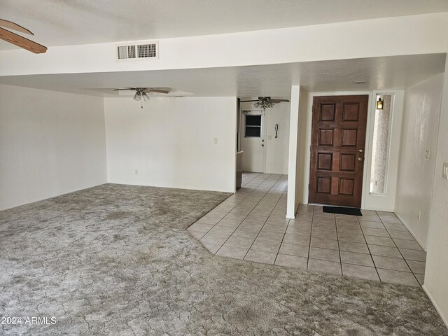 carpeted spare room with ceiling fan