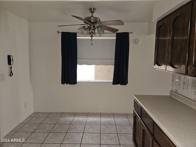 interior space featuring ceiling fan and light tile patterned flooring