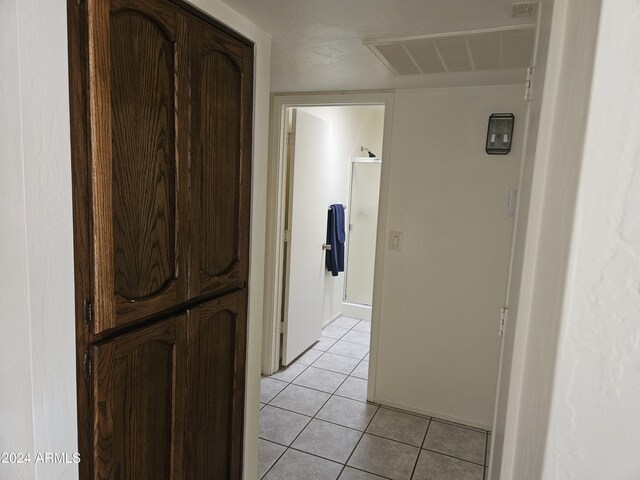 hall with light tile patterned floors