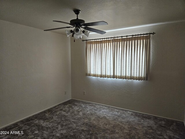 carpeted empty room with ceiling fan