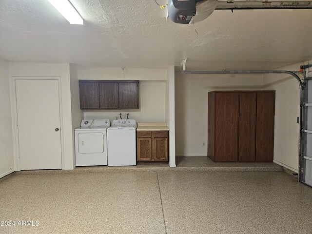 garage with washer and clothes dryer and a garage door opener