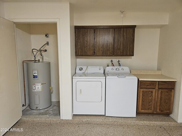 laundry area with cabinets, washing machine and dryer, and water heater