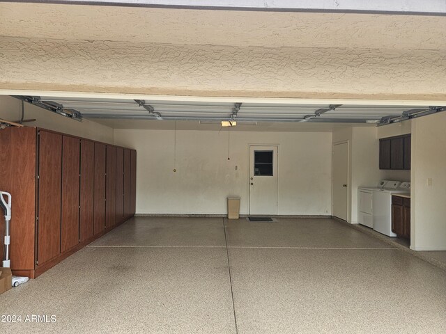 garage featuring washing machine and dryer