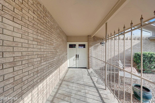 doorway to property featuring brick siding