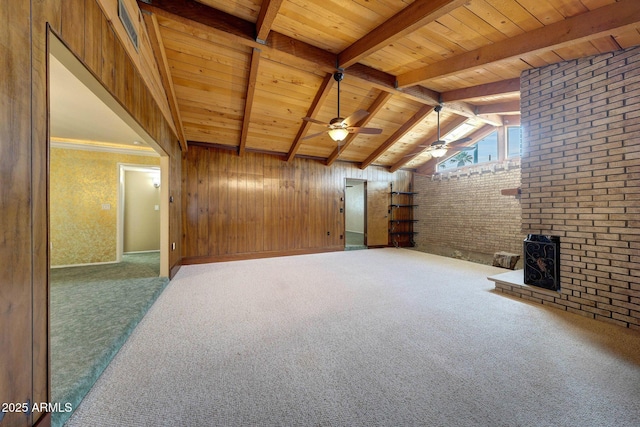 additional living space with lofted ceiling with beams, wooden ceiling, carpet floors, and wood walls