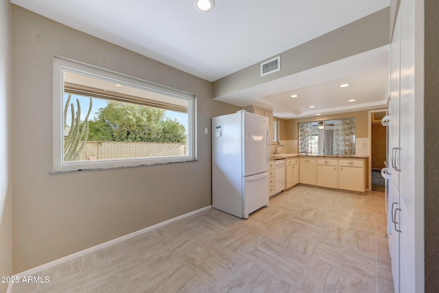 kitchen with light countertops, recessed lighting, white appliances, baseboards, and visible vents