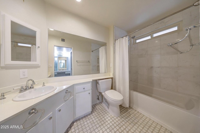 bathroom with toilet, shower / bath combo with shower curtain, and vanity