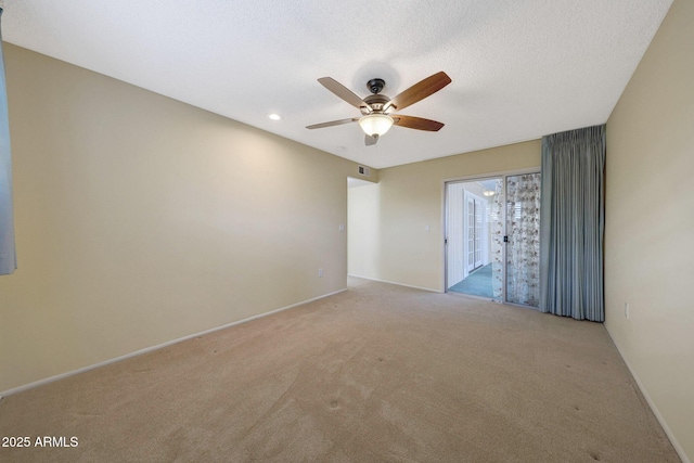 unfurnished room with a textured ceiling, ceiling fan, baseboards, and light carpet