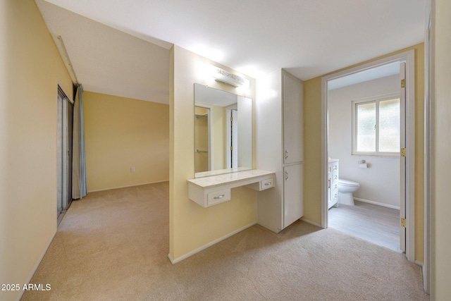 bathroom with baseboards, toilet, and carpet