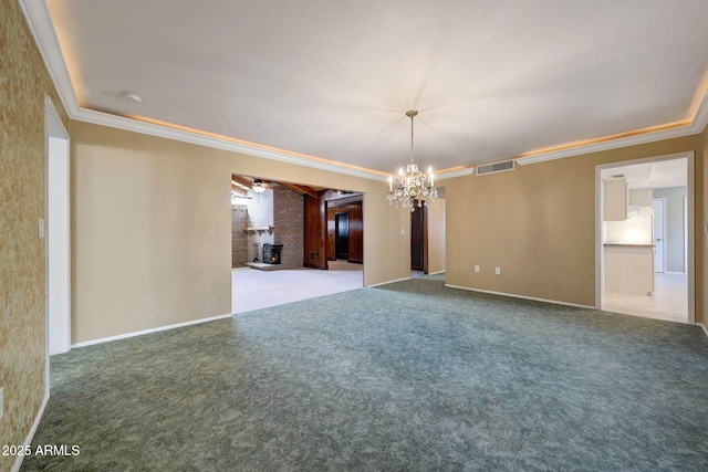carpeted empty room with baseboards, ornamental molding, visible vents, and a notable chandelier