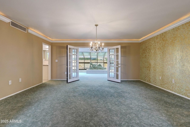 carpeted empty room with visible vents, crown molding, a notable chandelier, and french doors