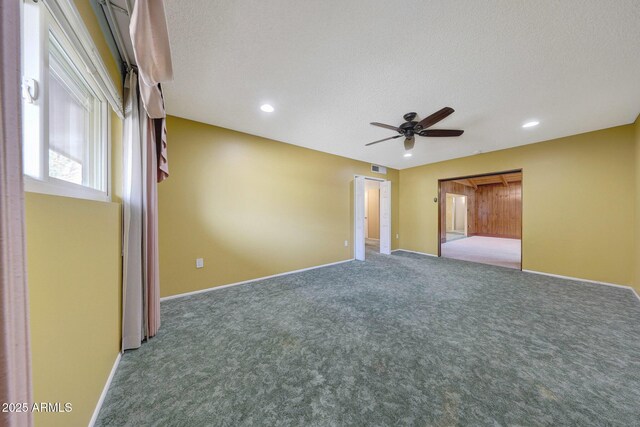 interior space featuring baseboards, carpet, and a textured ceiling