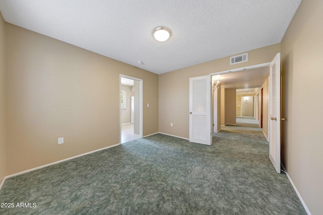 unfurnished bedroom featuring baseboards, a textured ceiling, visible vents, and carpet