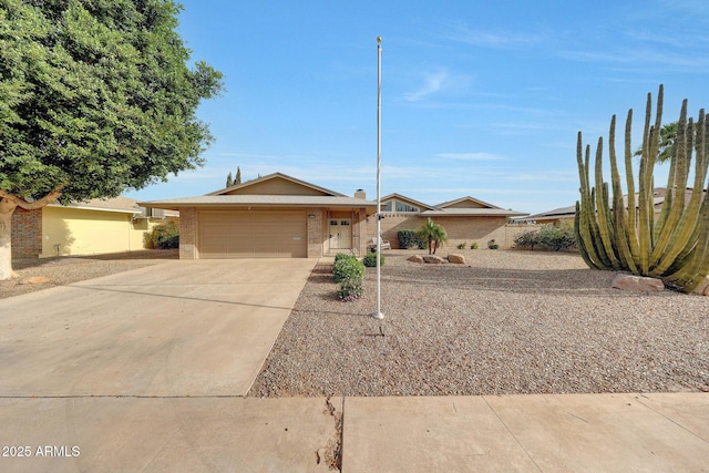 view of front of house with a garage, brick siding, and concrete driveway